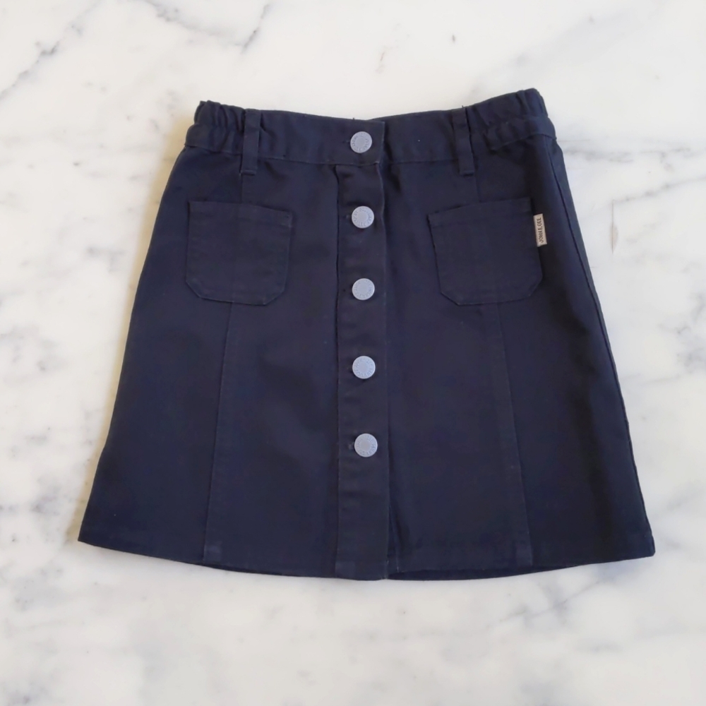 NWOT. John F. Gee Black Denim Skirt with Front Opening and Side Waist Elastic.
